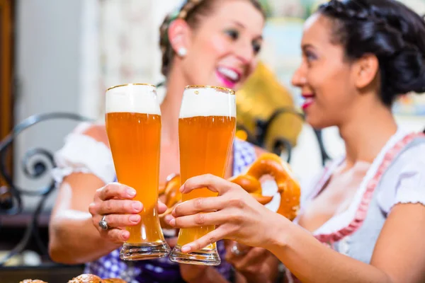 Girlfriends with Pretzel and Beer in Bavarian Inn — Stock Photo, Image