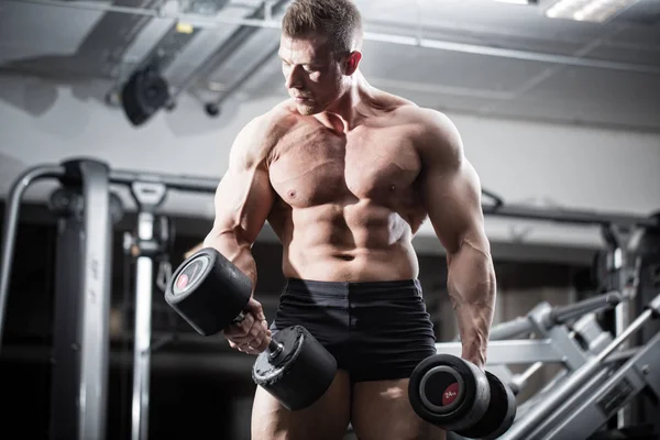 Bodybuilder in gym at fitness training with barbells — Stock Photo, Image