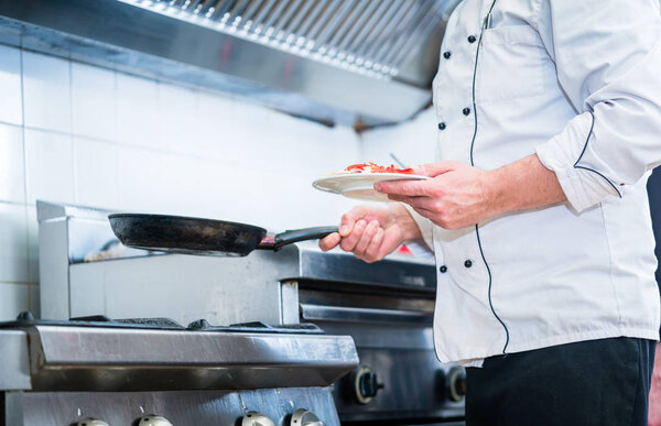 Chef with pan in restaurant kitchen