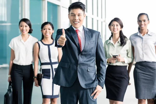 Bank staff in front of office showing thumbs up — Stock Photo, Image