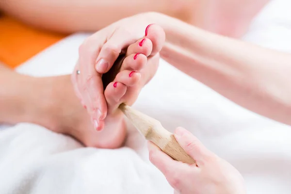 Women at reflexology having foot massaged — Stock Photo, Image