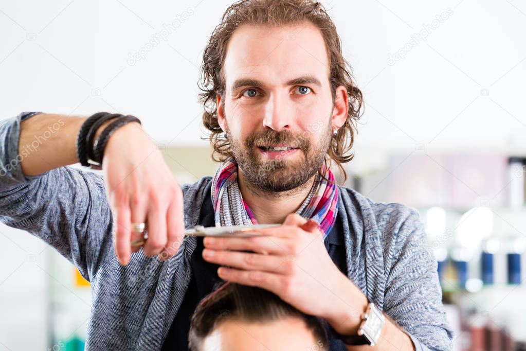 Barber trimming man hair in haircutter shop