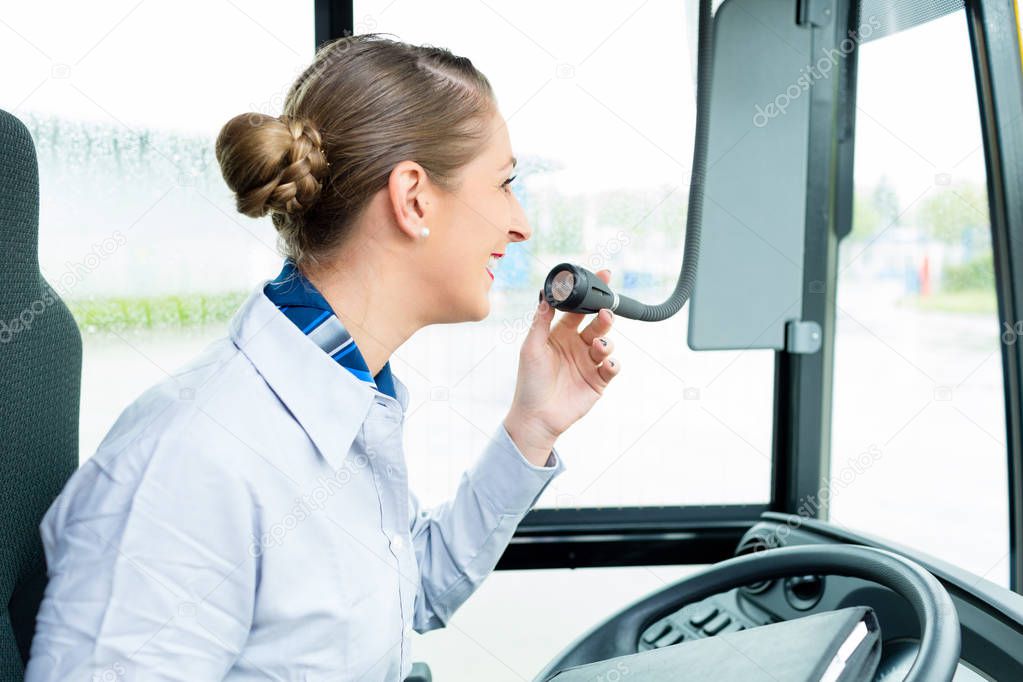 Bus driver woman speaking into the microphone