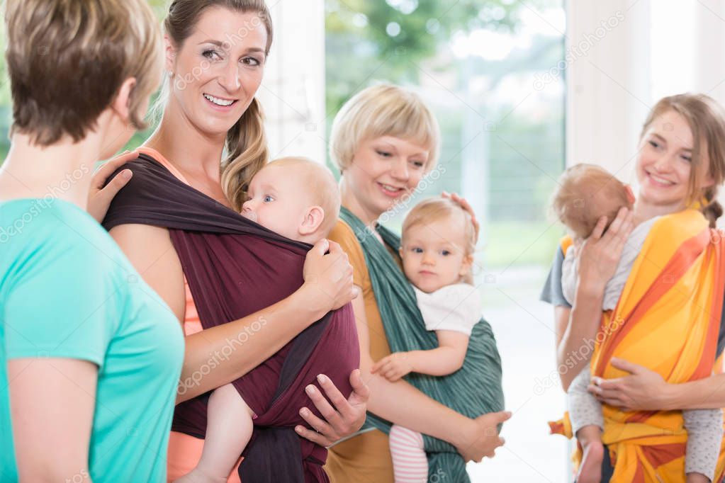 Group of women use baby slings