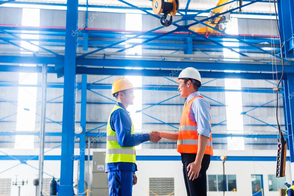 Worker and customer having agreement in factory