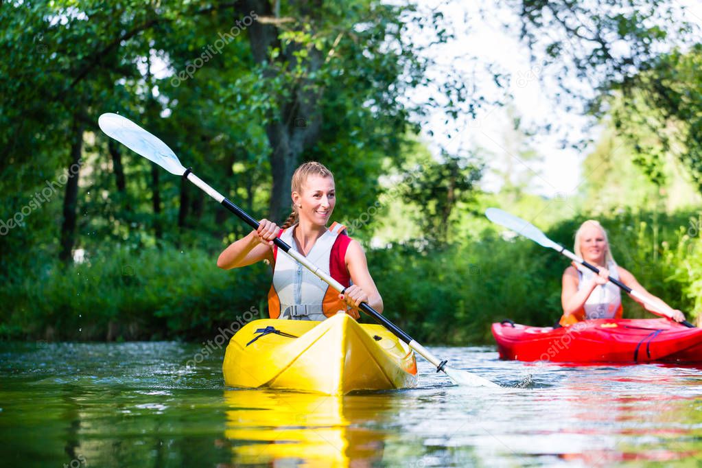 Women paddling with canoe 