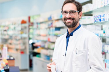 Apothecary in pharmacy standing at shelf clipart