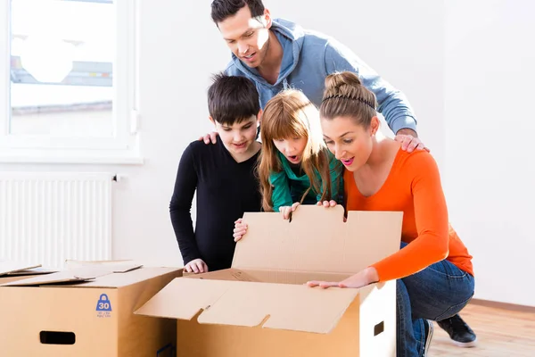 Family unpacking moving boxes — Stock Photo, Image