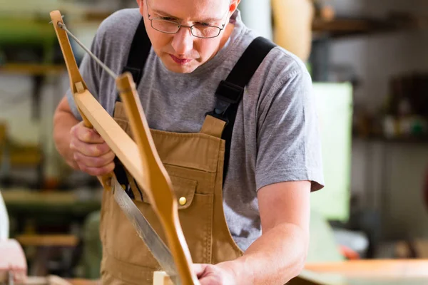 Carpenter using hand saw — Stock Photo, Image