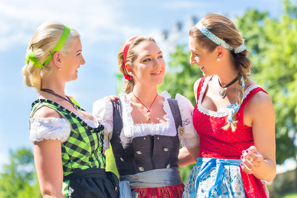 Friends visiting Bavarian fair having fun