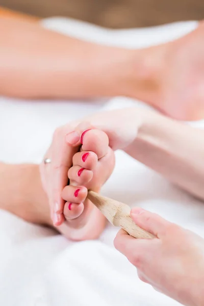 Women at reflexology having foot massaged — Stock Photo, Image