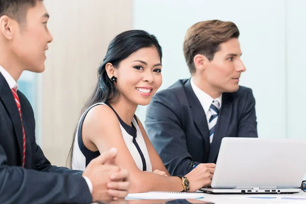 Business woman in meeting looking at camera — Stock Photo, Image