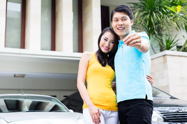 Chinesisches Paar zeigt Schlüssel für sein neues Zuhause — Stockfoto