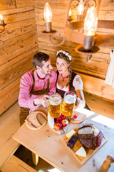 Couple having dinner at mountain hut in alps — Stock Photo, Image