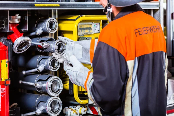 Brandweerman controleren de slangen — Stockfoto