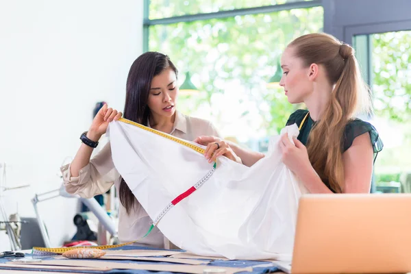 Designer women measuring cloth — Stock Photo, Image