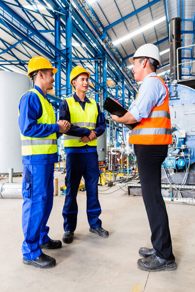 Asian factory worker and engineer as team