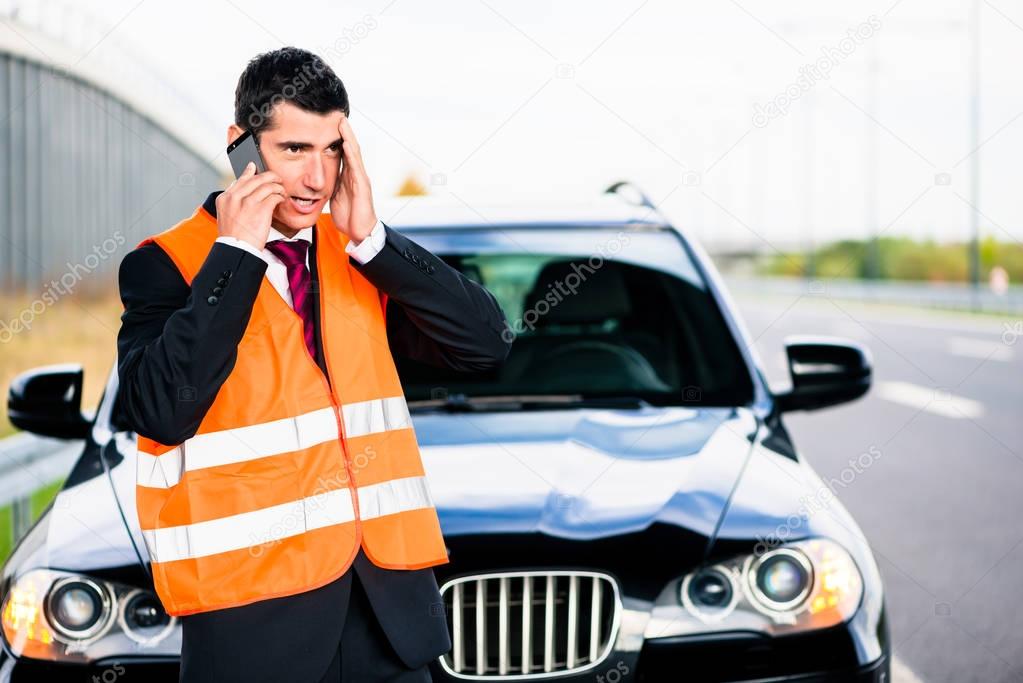 Man with car breakdown calling towing company