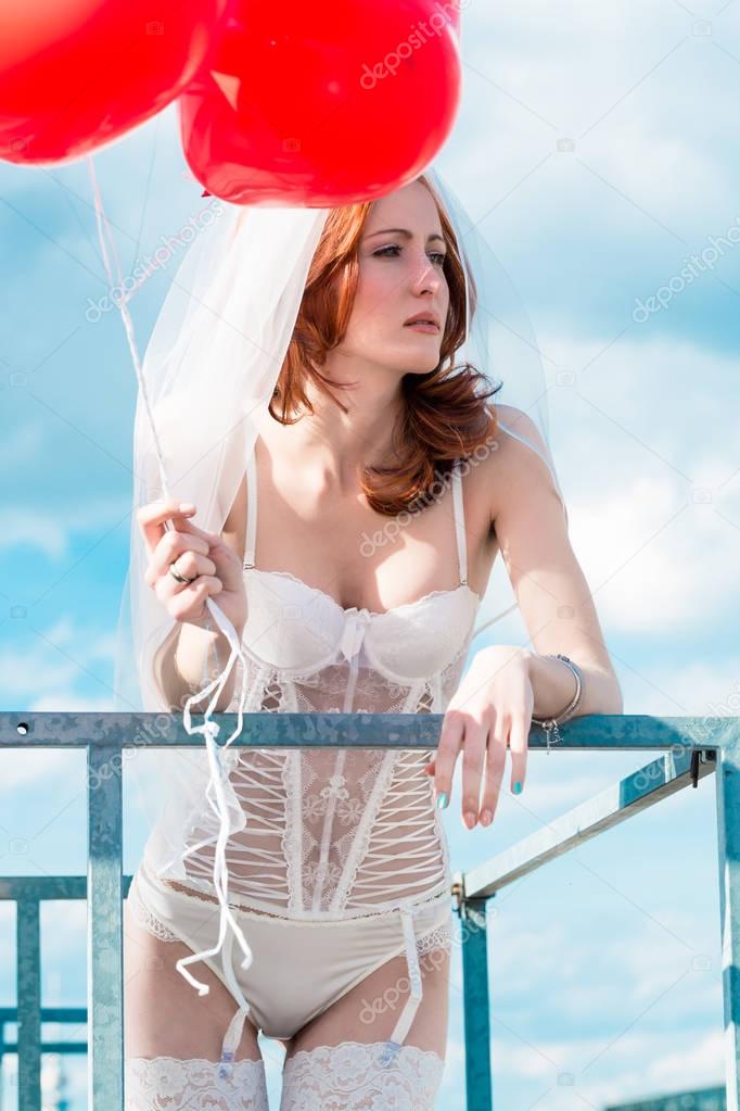 Bride with red balloons 