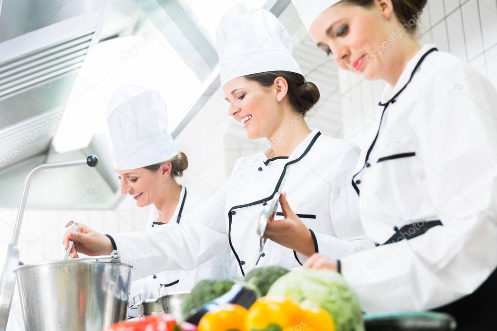 chefs preparing meals in commercial kitchen