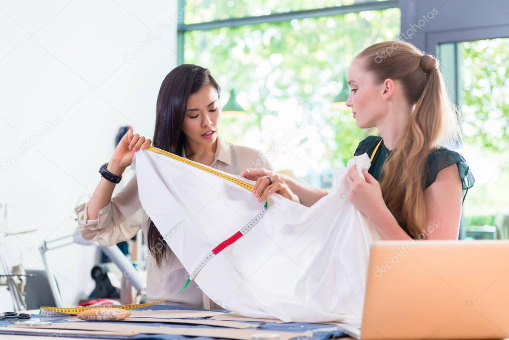 designer women measuring cloth 