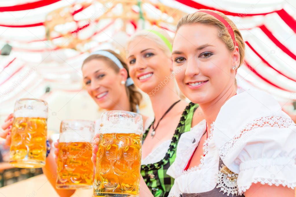 Friends drinking Bavarian beer at Oktoberfest 