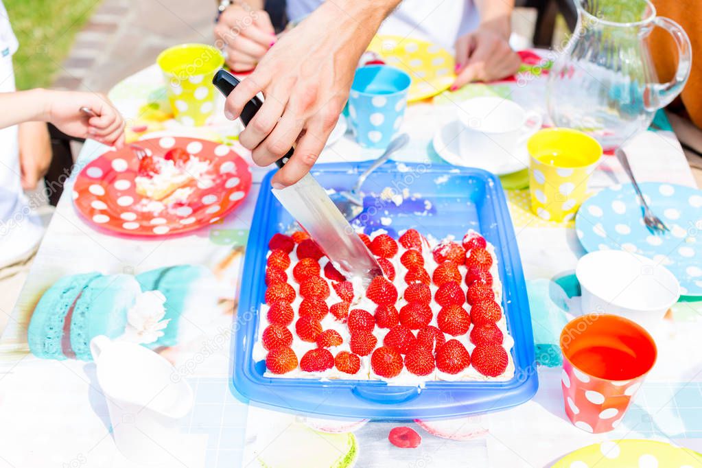 Family cutting fruit cake