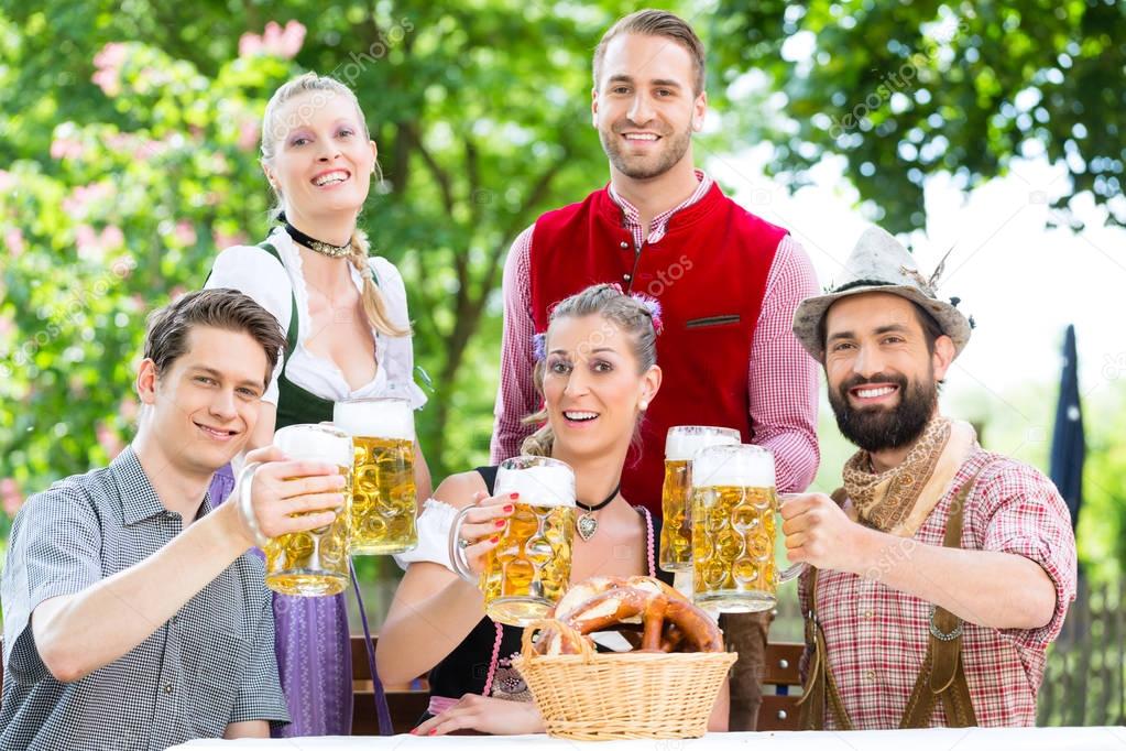 In Beer garden - friends drinking beer in Bavaria