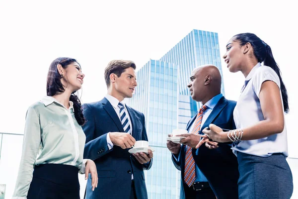 Business team in Asian city having casual coffee — Stock Photo, Image