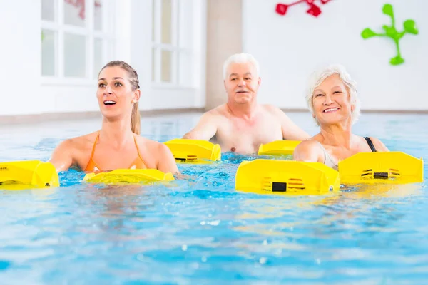 Senior and young people in water gymnastics — Stock Photo, Image