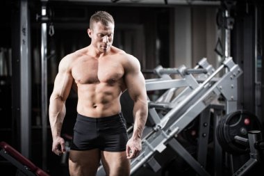 Spor salonunda vücut geliştirme yapan güçlü erkek