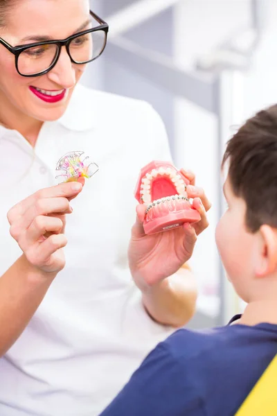 Ortodontista explicando aparelho de menino — Fotografia de Stock