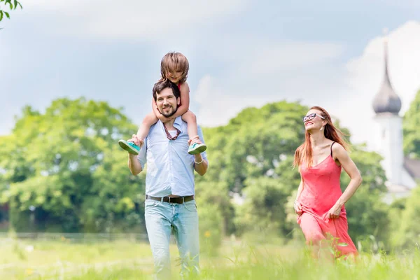 Familia caminando en el prado teniendo paseo — Foto de Stock