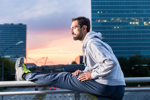 Runner stretching in front of office building — Stock Photo, Image