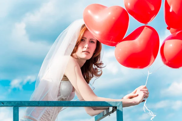Bride with red balloons