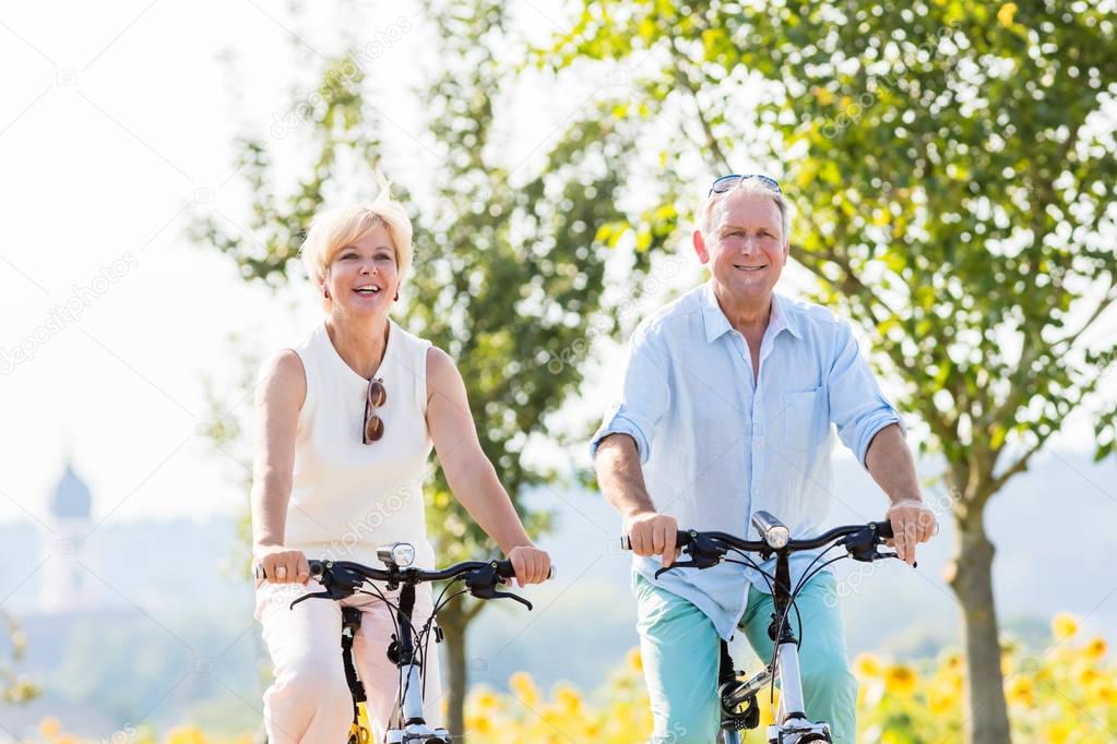 Senior couple riding their bikes