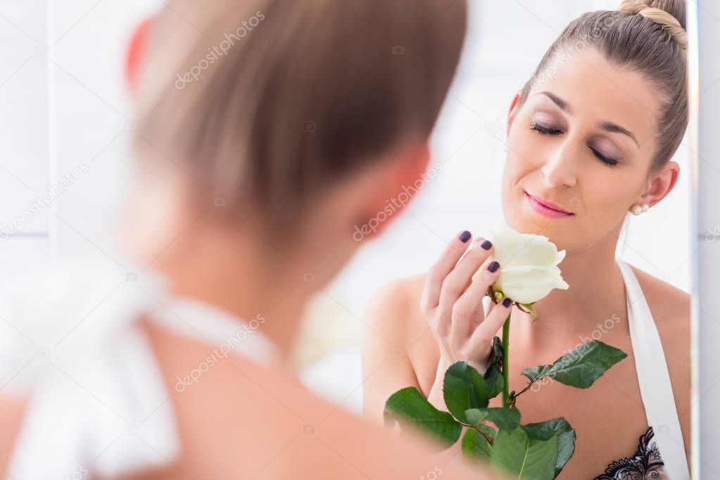 Woman holding white rose 
