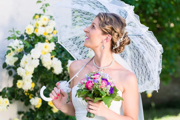 Bride at wedding with parasol — Stock Photo, Image