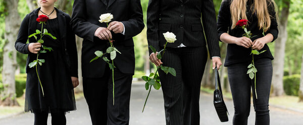 Torso of family on cemetery mourning