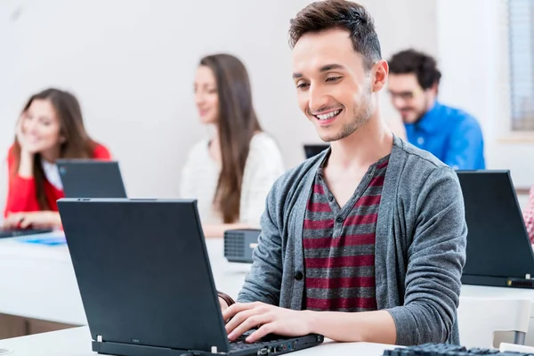 Student working on laptop PC in college — Stock Photo, Image