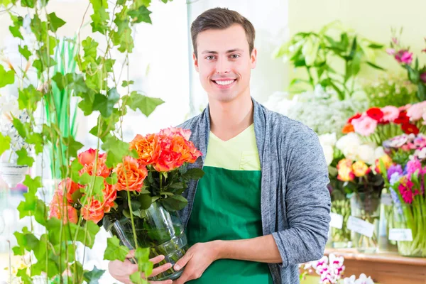Флорист работает в цветочном магазине — стоковое фото