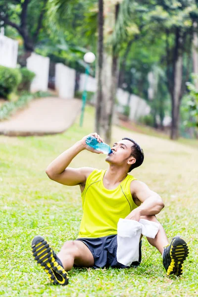 Asian man having break from sport training