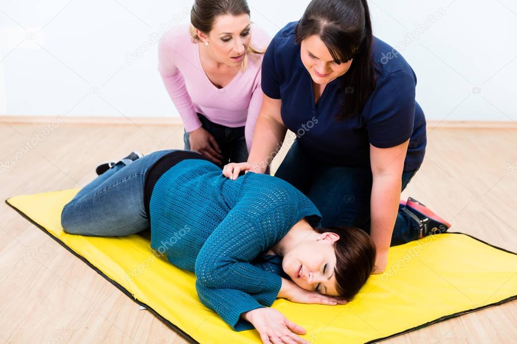 Women  training to position injured person