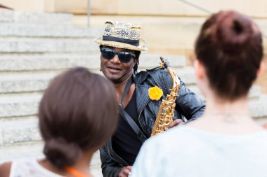 Güneş gözlüğü ve müzik yapma saksafon ile Black Street müzisyen