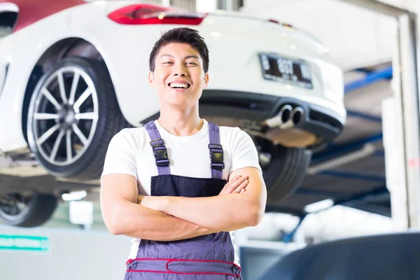 Automechaniker arbeitet in asiatischer chinesischer Autowerkstatt — Stockfoto
