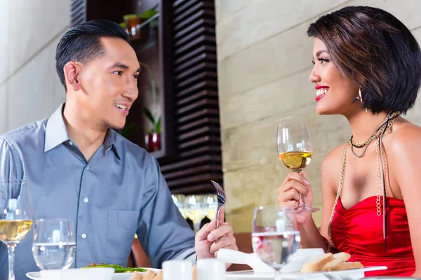 Asian couple fine dining in restaurant