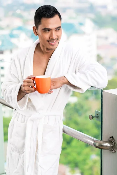 Asian man in morning front of city skyline — Stock Photo, Image
