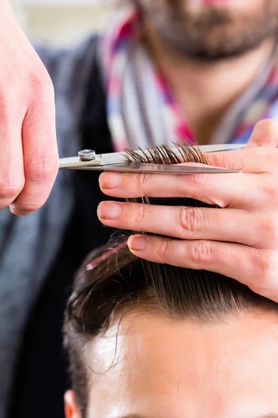 Barbeiro aparar o cabelo do homem — Fotografia de Stock