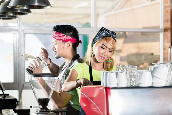 Wanita dan pria di kafe Asia menyiapkan kopi — Stok Foto