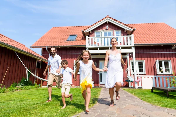 Happy family running on meadow — Stock Photo, Image